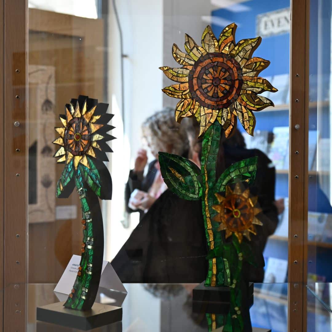 Girasoli in mosaico in una vetrina del Mosaic Temporary Shop